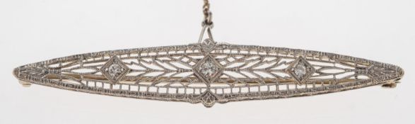 An openwork filigree diamond brooch, of navette form, set with three old-cut diamonds, safety chain,