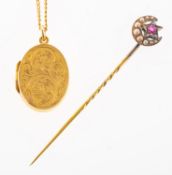 A locket with chain and a stick pin, an oval locket with foliate carving to the front panel,