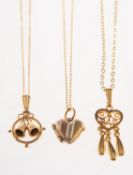 A group of three pendants with chains, including a small 9ct tri-colour heart locket,