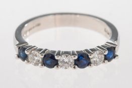 An 18ct gold sapphire and diamond half eternity ring,
