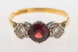 A three stone garnet and diamond ring,
