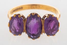 A 9ct gold amethyst ring, set with three oval-cut amethyst, UK hallmark, size P1/2 to Q, 3.4grams.