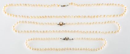 A group of three pearl necklaces,