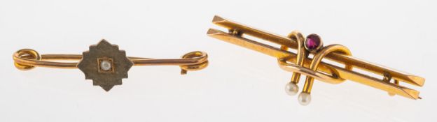 A group of two brooches,