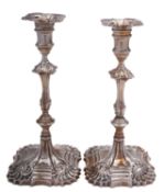A pair of George III silver cast candlesticks probably by Thomas Heming, London 1770,