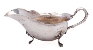 An Edward VII silver sauce boat by Jones & Crompton, Birmingham, 1906, with wavy rim,