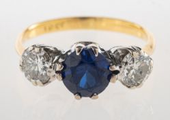 A synthetic sapphire and diamond three stone ring, a bi-metal ring,