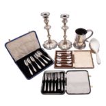 A mixed group of silver plate including; a pair of George III style candlesticks,