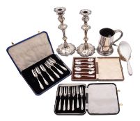 A mixed group of silver plate including; a pair of George III style candlesticks,