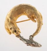 A 9ct yellow and white gold otter with fish brooch,