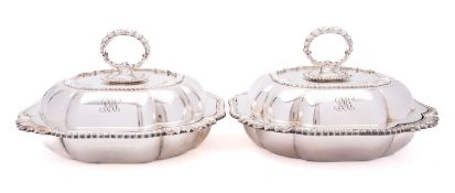 A pair of mid 20th century silver plated entree dishes, covers and handles by Asprey London,