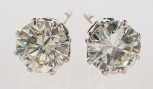 A pair of diamond stud earrings,