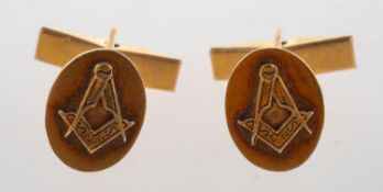 A pair of Masonic cufflink's, each oval plaque having a raised Masonic symbol,