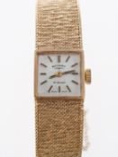 Rotary a 9K gold lady's wristwatch the square silvered dial having raised baton numerals and hands