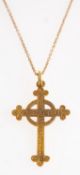 A cross pendant with chain, an ornately designed cross pendant with floral and foliate carving,