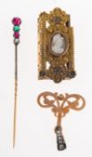 A small mixed group of jewellery, including a stick pin set with two circular-cut rubies,