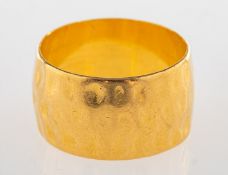A 1960's 22ct wide gold band, with a hammered finish, UK hallmark, size P to Q, width approx.
