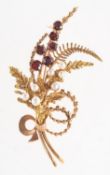 A 1970's 9ct gold garnet and pearl leaf spray brooch,
