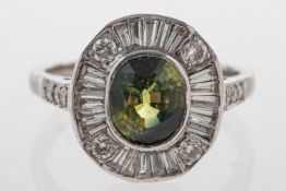A diamond and green sapphire cluster ring, collet set to the centre with an oval-cut green sapphire,