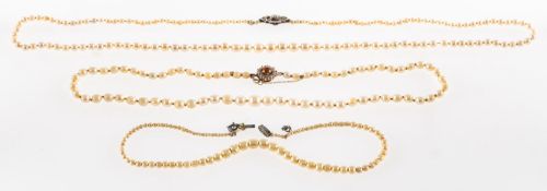 Two pearl necklaces and a faux pearl necklace, a graduated knotted string of cultured pearls,