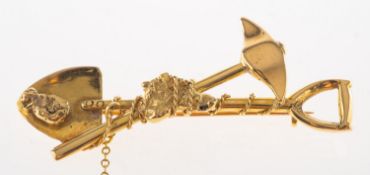 A miner's brooch, depicting a miner's pick and shovel with two 'gold nuggets',
