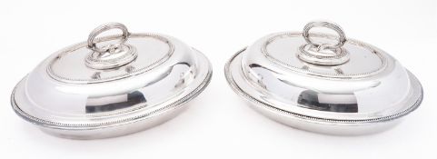 A pair of mid 20th century silver plated entree dishes, marks rubbed, of oval form,
