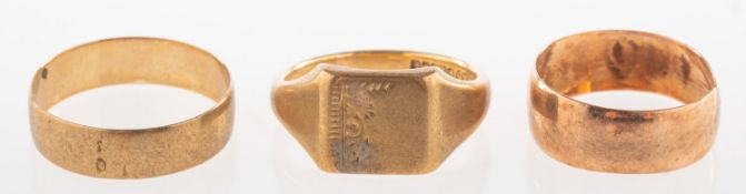A group of three 9ct gold rings, including a 9ct gold wedding band, UK hallmark, size T, 1.