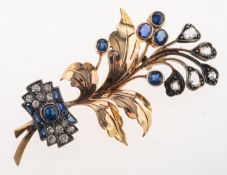 A sapphire and diamond flower spray brooch, (possibly circa 1920's to 1930's), of bi-metal,