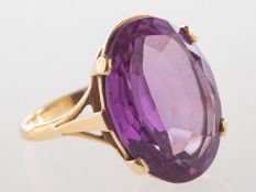 A cocktail ring, claw set with an oval-cut synthetic alexandrite, unmarked yellow metal,