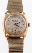 Buren Grand Prix a 9K gold wristwatch the round two-tone silvered dial having black Arabic numerals,