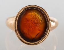 An antique carved intaglio ring, an oval carnelian carved plaque, depicting a gentleman's bust,