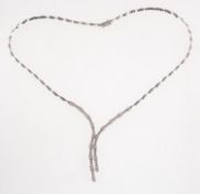 A diamond lariat necklace, of articulated curved bar links to a diamond set lariat centrepiece,