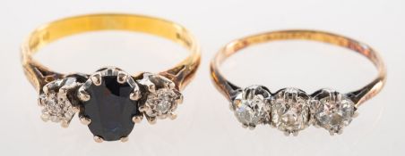 A diamond and sapphire ring and a three stone diamond ring, an 18ct gold three stone ring,