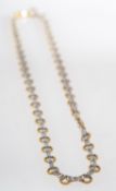 A bi-colour fancy link necklace, made up of alternating twisted circular links,