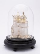 A Victorian silver-gilt and glass three-bottle spice cruet set by John William Figg, London 1872,
