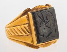 A carved hematite signet ring, set with a rectangular plaque of hematite,