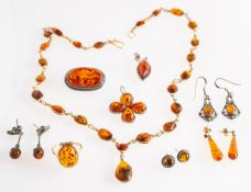 A mixed group of amber jewellery, including a ring set with an oval amber cabochon, marked 375,