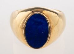 A lapis lazuli signet ring, the ring collet set with an oval plaque of lapis lazuli, marked 14K,