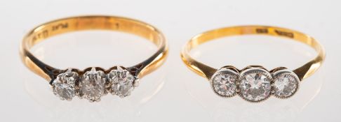 Two three stone diamond rings,