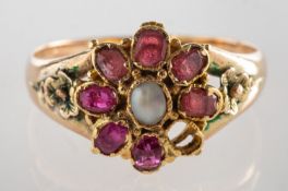 A flowerhead ring, the flowerhead set centrally with an oval white stone cabochon,