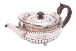 A George III silver tea pot by J W Story & W Elliott, London 1809, of compressed circular form,