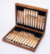 A cased set of twelve Edward VIII silver and mother of pearl fruit knives and forks by Goldsmiths