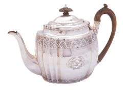 A George III silver tea pot by Thomas Wallis II, London 1801, of shaped oval form,