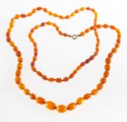 A string of butterscotch 'amber type' beads, of graduated oval beads, knotted, length approx. 94.