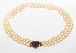 A pearl choker necklace, a lattice style choker necklace made up of small cultured pearls,