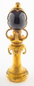 A Georgian gilt seal in fitted case, an ornate floral and foliate carved freestanding gilt seal,