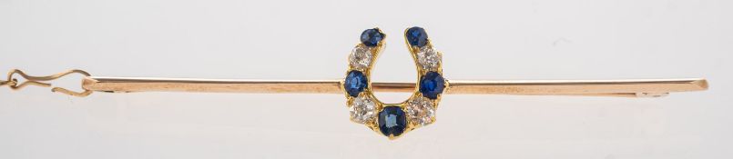 A sapphire and diamond horseshoe brooch, a bar brooch set centrally with a horseshoe,
