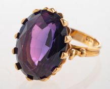 A synthetic alexandrite ring, claw set with an oval-cut synthetic alexandrite, fluted gallery,