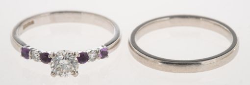 A platinum diamond and amethyst ring and a platinum wedding band,