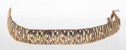 A 1970's 9ct gold bracelet, of openwork articulated textured and polished 'bark' effect links,